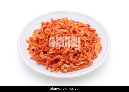 Dried chopped carrots in a bowl isolated on white background Stock Photo