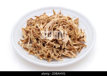 chinese medicine, dried plants in a plate on white background. Stock Photo