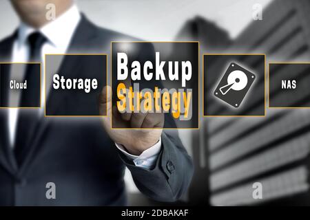 Backup Strategy touchscreen is operated by a businessman. Stock Photo