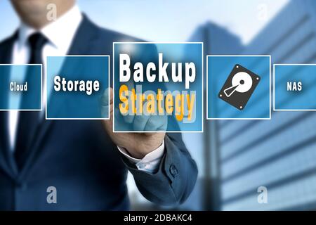 Backup Strategy touchscreen is operated by a businessman. Stock Photo