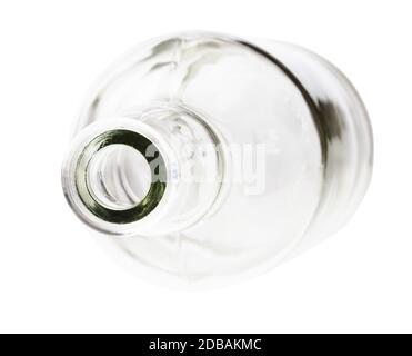 overturned empty clear brandy bottle isolated on white background Stock Photo