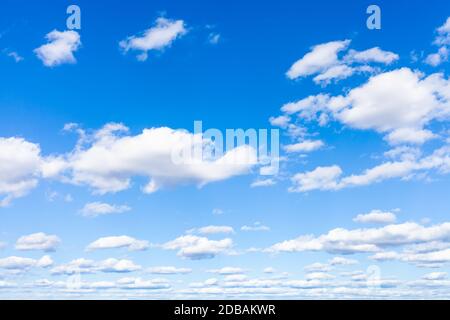 blue sky with many white small cumulus clouds on sunny March day Stock Photo