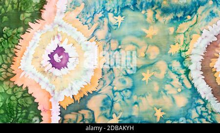 abstract ornament handmade in tie-dye and hot batik technique isolated on colored silk scarf Stock Photo