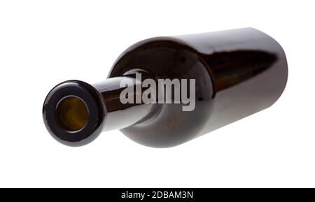 overturned empty dark brown wine bottle isolated on white background Stock Photo