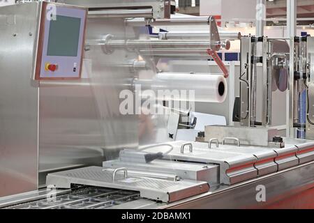 Foil Packing Machine at Production Line in Food Factory Stock Photo