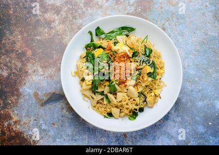 Fried noodles with Vietnamese Grilled Pork Sausage, eggs and Gnetum gnemon leaves Stock Photo