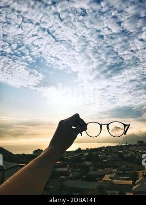Skyscape through sunglasses. Glasses allowing person to see the beauty of nature - great illustration for sunglasses manufacturing company or a travel agency. Place for text copy Stock Photo