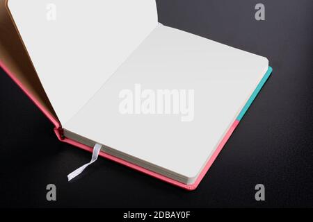 Opened daily planner notebook with smart object pages on dark black background Stock Photo