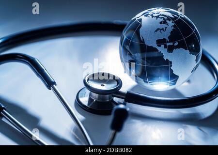 Glass globe and stethoscope on gray background Stock Photo