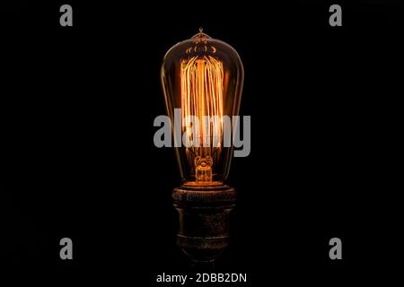Edison light bulb on black background Stock Photo