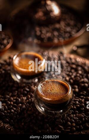 Hot coffee in a glass with double walls on coffee beans background Stock Photo