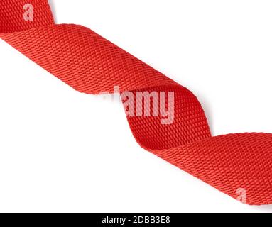 twisted red textile tape for belts and handles of bags isolated on a white background Stock Photo