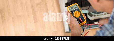 Testing Electric Appliance Using Multimeter To Repair Fridge At Home Stock Photo
