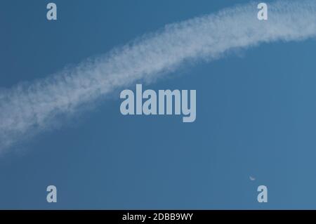 Aircraft vapour trail and moon. Gran Canaria. Canary Islands. Spain. Stock Photo