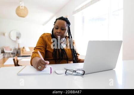 Woman working from at desk Stock Photo