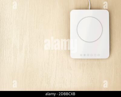 White ceramic or induction cooktop on wood table, top view Stock Photo