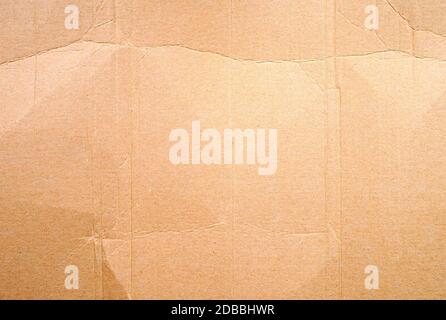 Full frame texture of blank crumpled and wrinkled brown cardboard background. Stock Photo