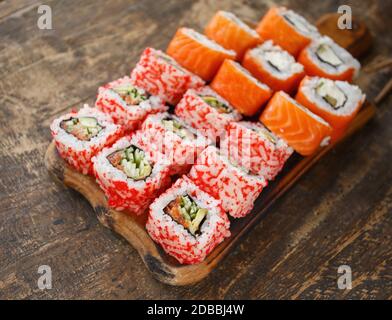 Set of two types of sushi. Sushi on brown wooden board and rustic style. Japanese food Stock Photo