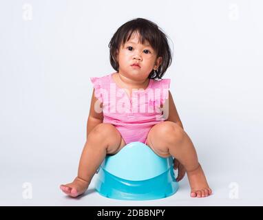 Potty training a toddler girl in home washroom Stock Photo - Alamy