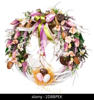 Easter wreath on a white background. Decoration of tulips, small pink and white flowers, greens and natural components. Colored ribbons and burlap. Ne Stock Photo