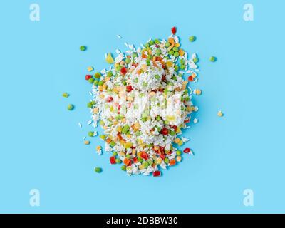 Frozen vegetables assorted on blue background. Assorted frozen vegetables food with ice, top view or flat lay. Raw uncooked frozen hawaii mix Stock Photo