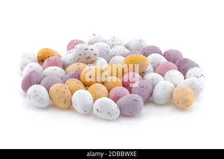 A selection of Yellow pink purple and white Easter candy eggs isolated on a white background Stock Photo