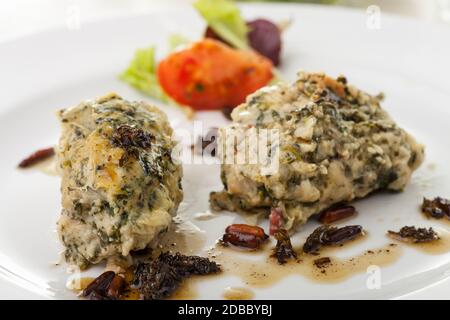 italian strangolapreti dumplings on a plate Stock Photo