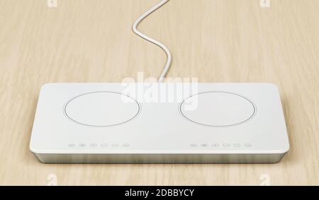 White induction cooktop on wood table Stock Photo