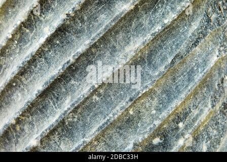Natural stone texture with longitudinal stripes and surface background in high resolution. Stock Photo