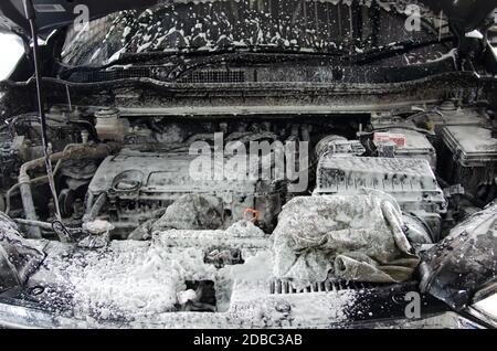 Wash the engine with car wash foam.Clean the engine at the car care shop. Stock Photo