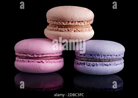 Three macaroon pyramid on black background with reflaction Stock Photo
