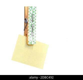 Yellow stick note paper pinned on wooden peg isolated on white background. Copy space for other notes on right side. Stock Photo