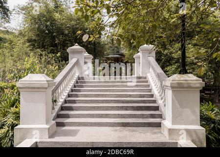 Beautiful white Bridge over the lake and river Tasik Perdana to the Bamboo Playhouse in the Perdana Botanical Gardens in Kuala Lumpur, Malaysia. Stock Photo