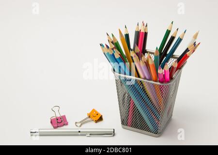 A group of colored pencils for students in a writing-glass on a white background Stock Photo