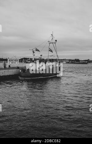 on a landing stage an old fishing boat is moored Stock Photo