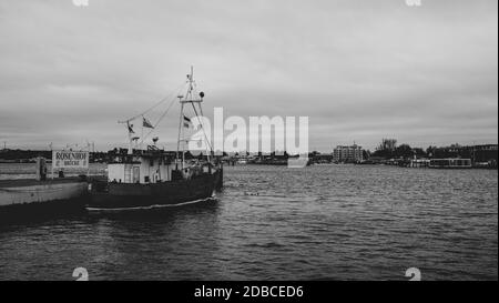 on a landing stage an old fishing boat is moored Stock Photo