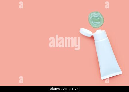 Alcohol hand sanitizer gel in white glossy plastic tube for hygiene corona virus (Covid-19) protection. Pink background with copy space Stock Photo