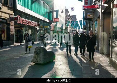 Stockholm - 02/07/2017: people strolling on drottninggatan stockholm with typical statues Stock Photo