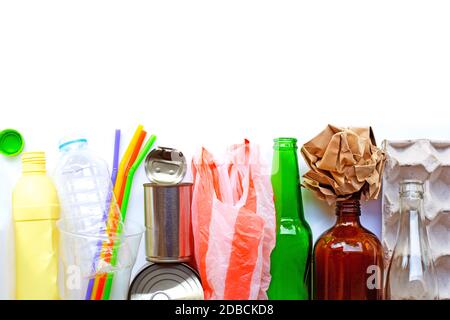 Recyclable garbage, plastic bottle, glass bottle, can and egg paper tray on brown plywood background. Copy space Stock Photo