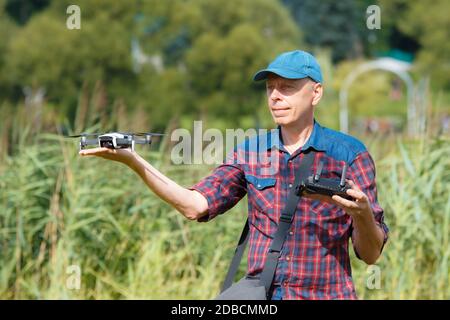 A man launches a drone from his hand. A man holds a drone on his outstretched arm Stock Photo