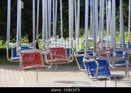 Empty hanging seats for children on the carousel. Amusement park Divo-island. Saint-Petersburg. Stock Photo