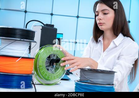 Young woman use 3d printer at office Stock Photo