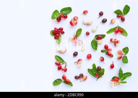 Carunda or Karonda fruits with leaves isolated on white background. Copy space Stock Photo