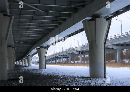 Under bridge massive concrete construction. Perspective view. Cold winter landscape. Stock Photo