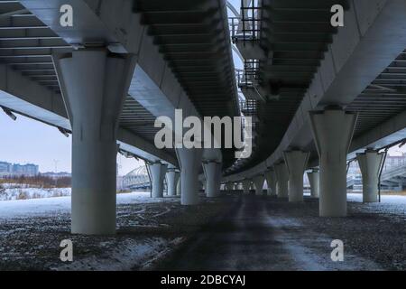 Under bridge massive concrete construction. Perspective view. Cold winter landscape. Stock Photo