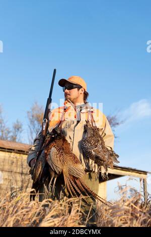 A hunter in North Dakota after a succesful day of pheasant hunting Stock Photo