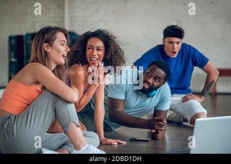 Colleagues discussing foreign dance videos from internet Stock Photo
