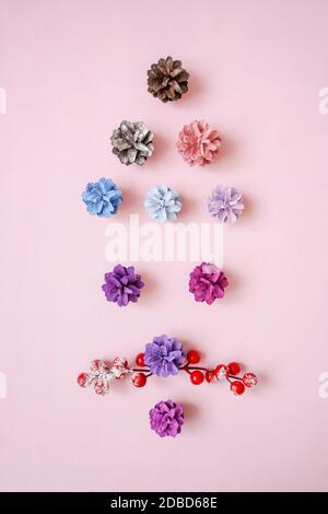 Face santa claus from multi-colored pine cones and berries on pink background. Flat lay, top view. Stock Photo