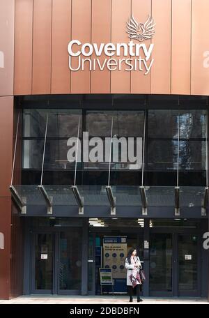 A student stands at the entrance and exit to and from the Alan Berry building (which houses the vice chancellor's office) at the university of Coventr Stock Photo