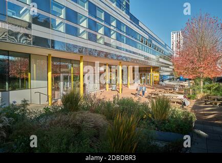 Students in the forecourt of The Hub buildng at the university of Coventry, England, on a sunny autumn day. Stock Photo